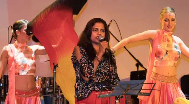 Image of Desi Nach performing alongside bollywood signer.
